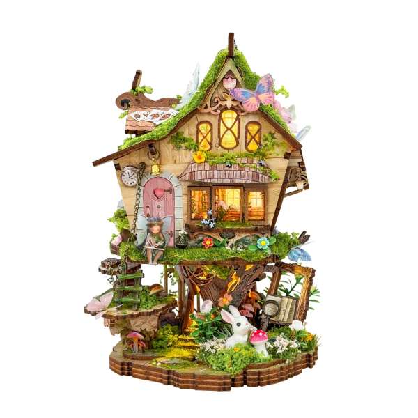 Decorative fairy house with moss, flowers, butterflies, and a rabbit figurine