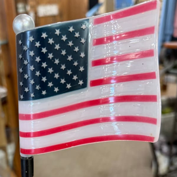 Decorative American flag on a black pole