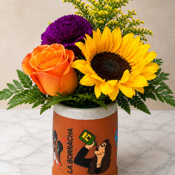 Orange rose, yellow sunflower, and purple chrysanthemum in a painted vase