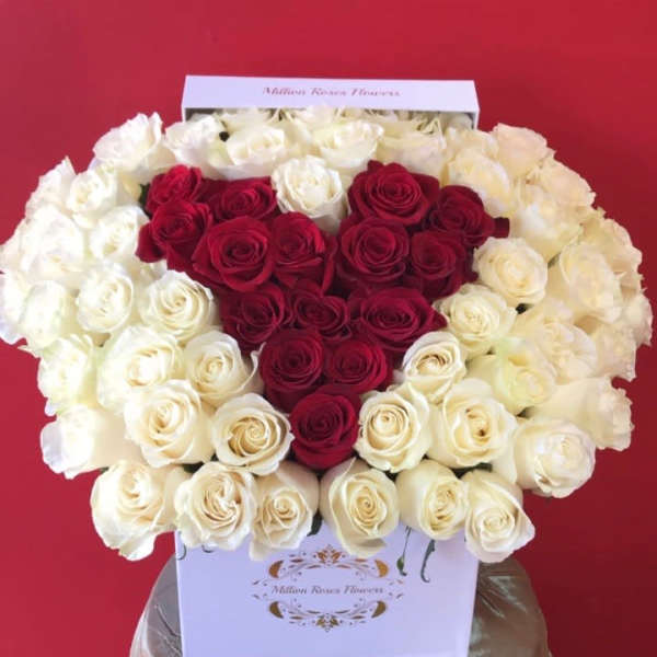 Heart-shaped red and white rose arrangement in a white box