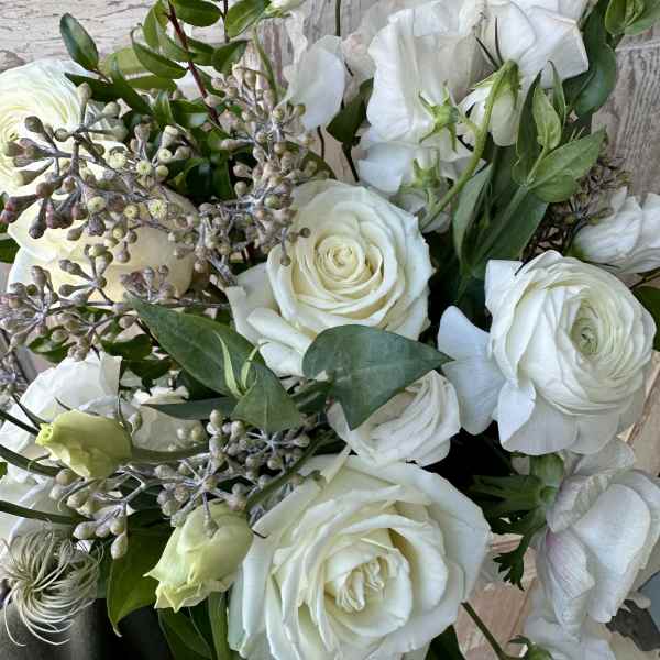 White rose bouquet with white lisianthus and greenery