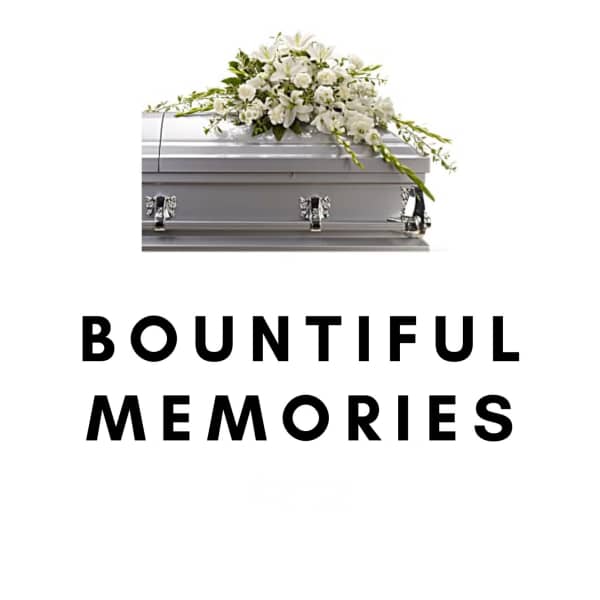 White floral spray on a silver casket