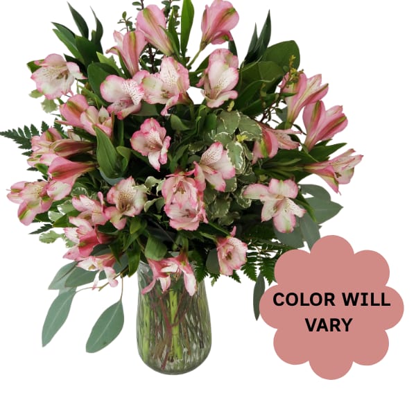 Pink alstroemeria bouquet in a glass vase with a color-will-vary note