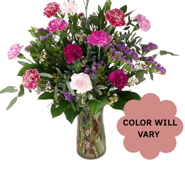 Mixed pink and purple carnations in a glass vase
