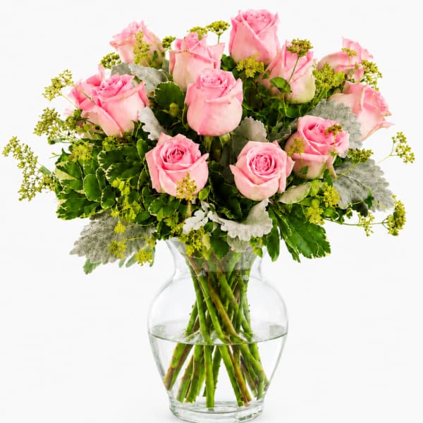 Pink roses arranged in a clear glass vase