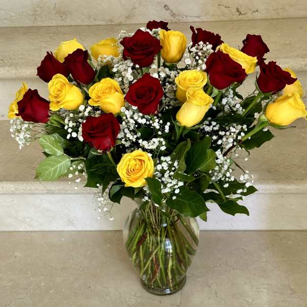 Bouquet of red and yellow roses in a glass vase