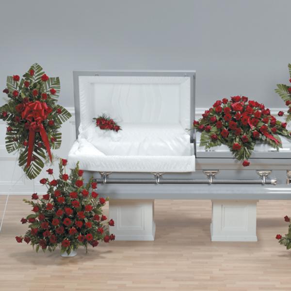 Red rose funeral casket spray with matching standing arrangements