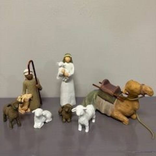 Small nativity figurines with a baby in a manger and two animals