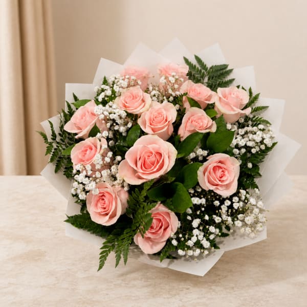 Bouquet of pale pink roses with white filler flowers and greenery