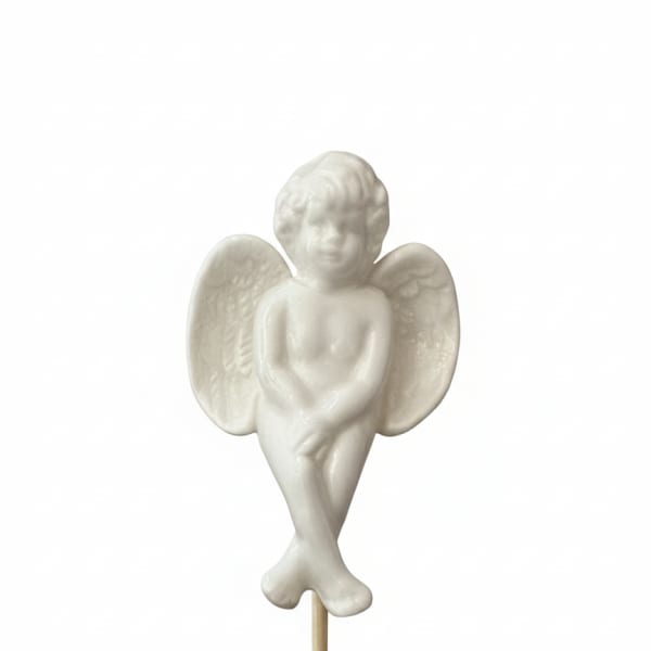 White angel figurine on a wooden stick