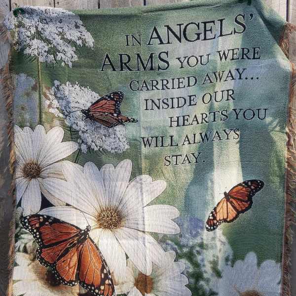 Memorial blanket with white daisies, butterflies, and a remembrance message