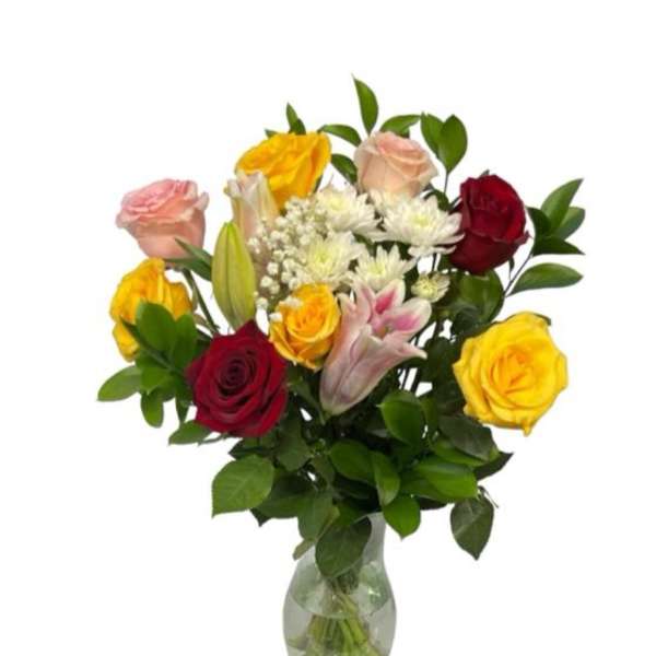Mixed roses and lilies arranged in a clear glass vase