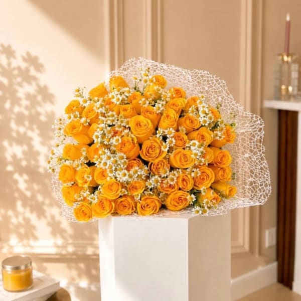 Bouquet of yellow roses and small white daisies in white wrap