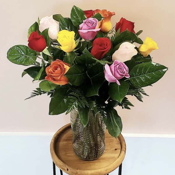 Bouquet of multicolored roses in a glass vase