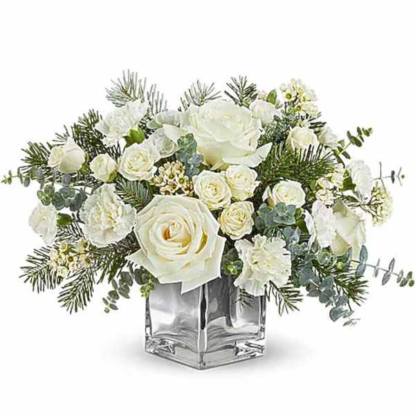 White roses and carnations in a clear square vase