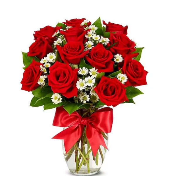 Red roses and white daisies in a glass vase with a red ribbon