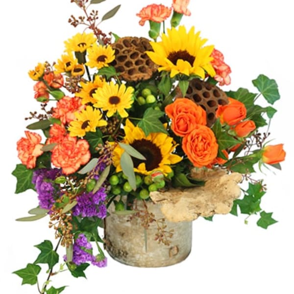 Mixed bouquet with sunflowers, orange roses, and carnations in a rustic container