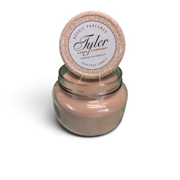 Pink scented candle in a glass jar with a lid