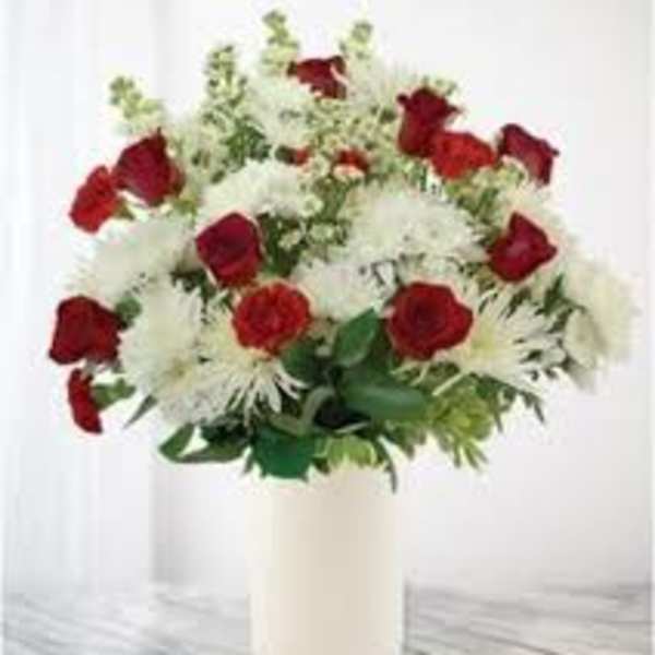 Red roses and white chrysanthemums in a white vase
