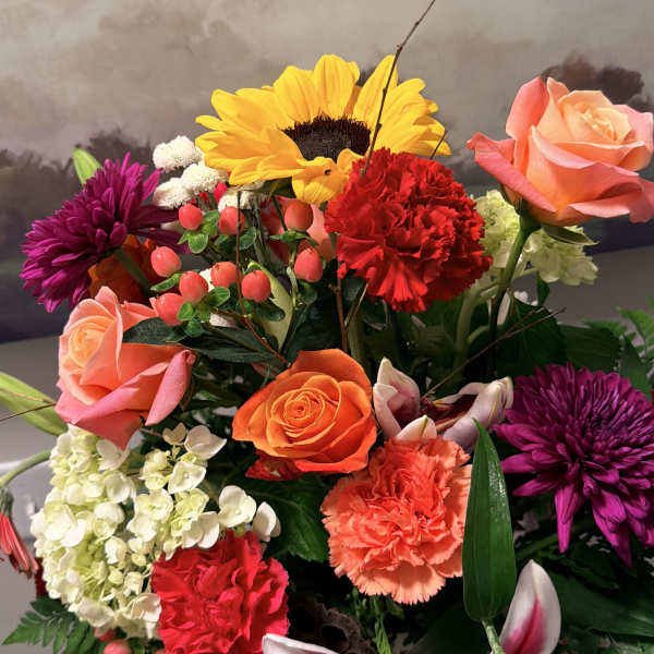 Mixed bouquet with roses, lilies, sunflowers, and carnations