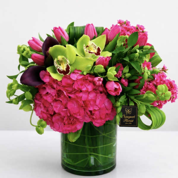 Pink and green floral arrangement in a glass vase