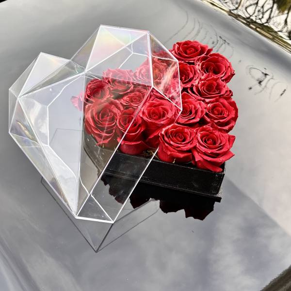 Box of red roses with a clear geometric lid