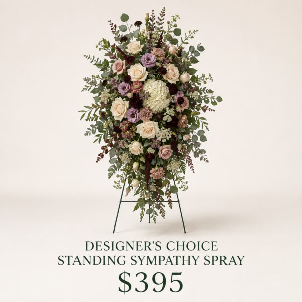 Standing sympathy spray with roses, hydrangea, and mixed greenery on an easel