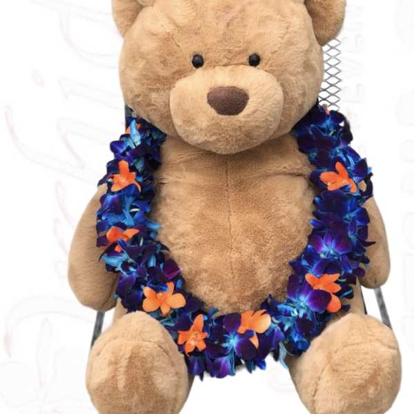 Plush teddy bear wearing a colorful flower lei