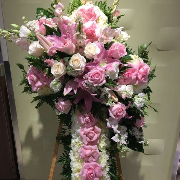 Large pink and white floral standing spray on an easel