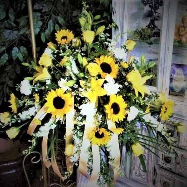 Yellow sunflower arrangement with white flowers and ribbon streamers