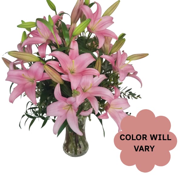 Pink lilies arranged in a clear glass vase