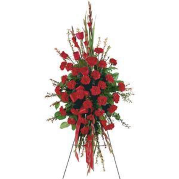 Tall standing spray of red carnations on an easel