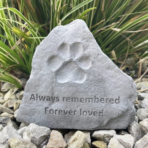 Gray memorial stone with a paw print and the words Always remembered, Forever loved