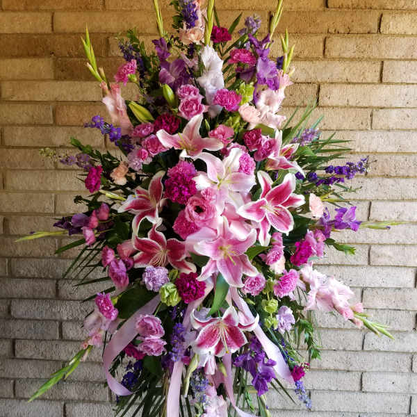 Large standing spray of pink and purple lilies and carnations