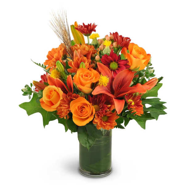 Orange and red mixed bouquet in a glass vase