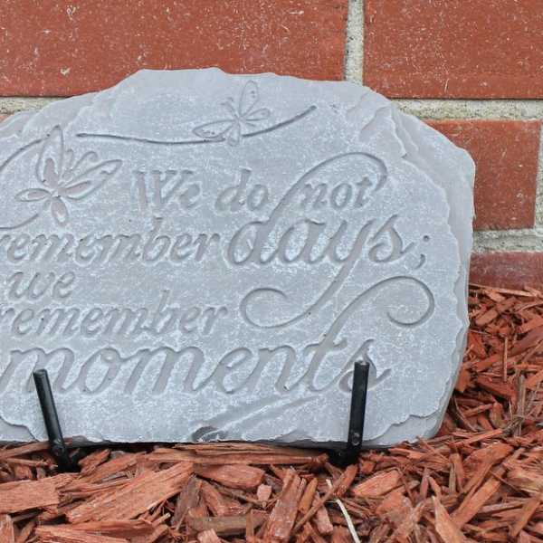 Decorative stone plaque with the words "We do not remember days, we remember moments."
