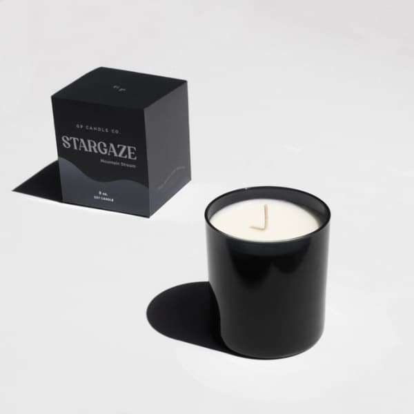 Black candle in a glass jar with a matching box
