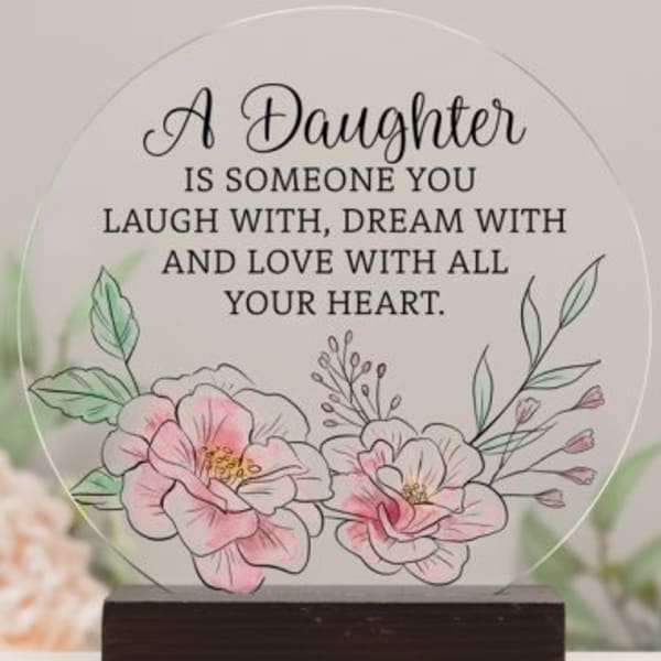 Decorative plaque with floral illustration and daughter quote on a wooden base