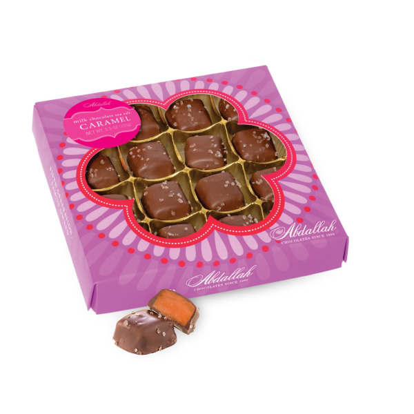 Box of milk chocolate sea salt caramels with one piece outside the box