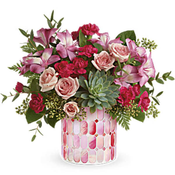 Pink and blush floral arrangement in a patterned glass vase