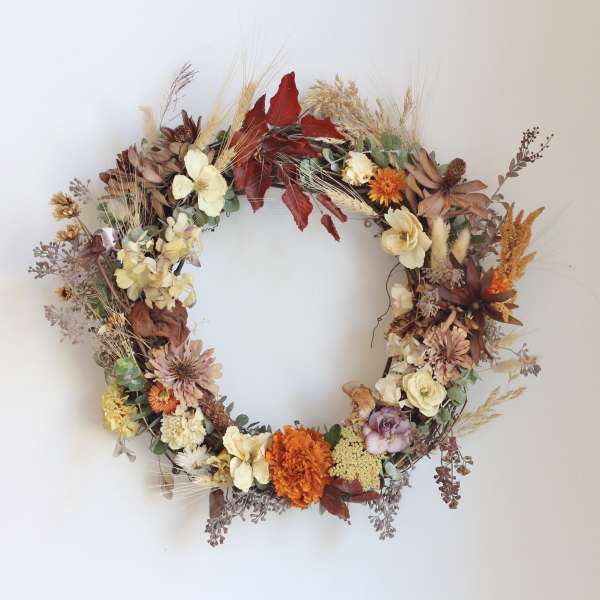 Autumn floral wreath with cream, orange, and burgundy blooms