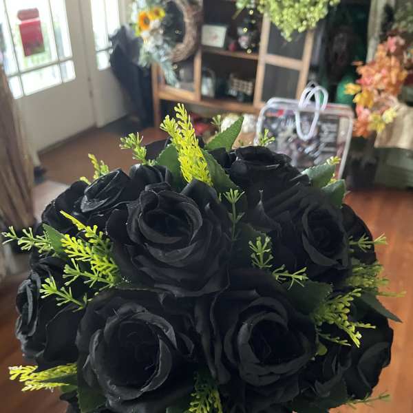 Bouquet of black roses with bright green filler