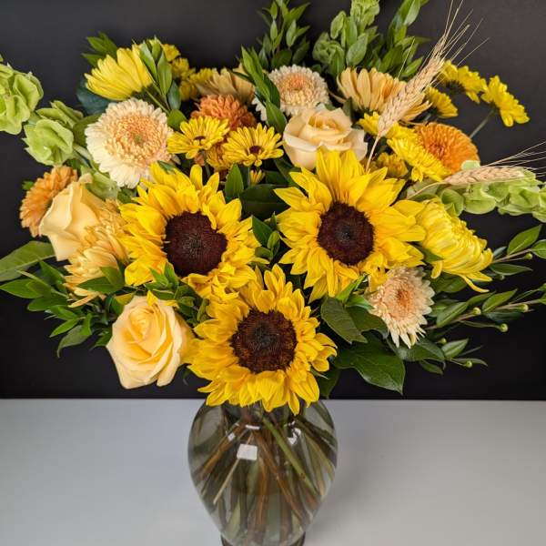 Sunflower and rose bouquet in a glass vase
