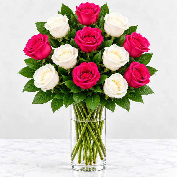 Bouquet of pink and white roses in a clear glass vase