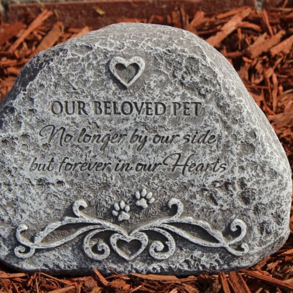 Memorial stone engraved with "Our Beloved Pet" and a heart design