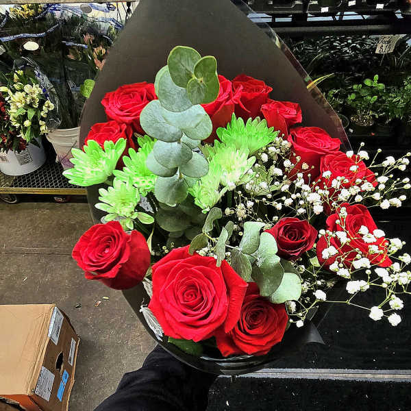 Bouquet of red roses with green chrysanthemums and white baby's breath