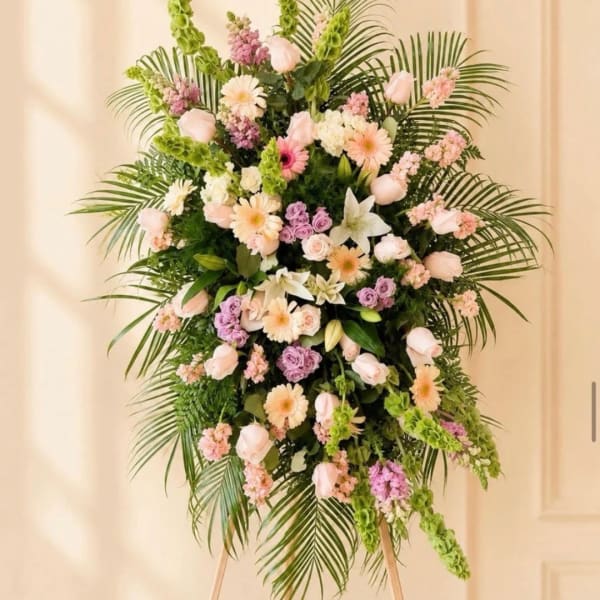 Tall pastel floral standing spray with pink, white, and lavender blooms