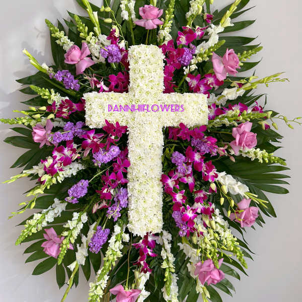 Large floral cross with pink, white, and purple flowers