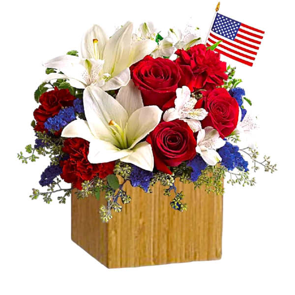 Red roses and white lilies in a wooden box with a small American flag