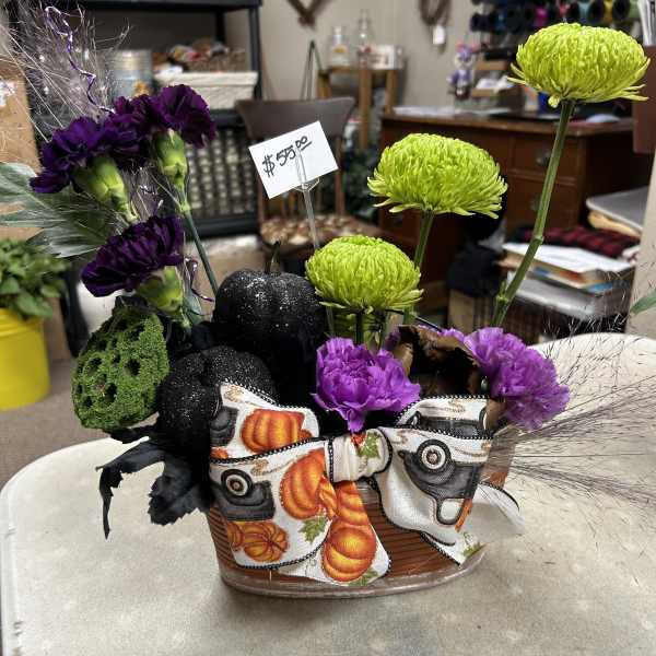 Halloween floral basket with purple carnations and green chrysanthemums
